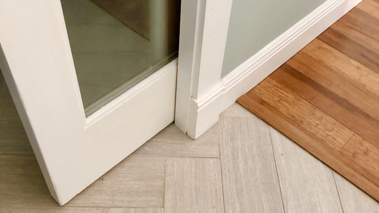 bottom of a pocket door sliding into a wall