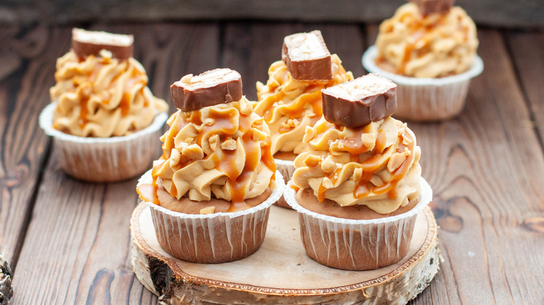 cupcakes topped with peanut butter frosting and caramel