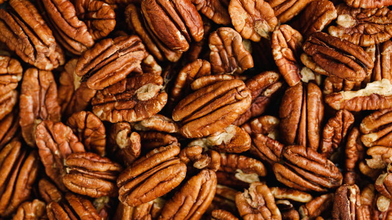Close-up of several harvested pecans without shells.