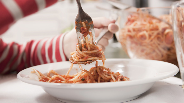 Hand twisting spaghetti on fork