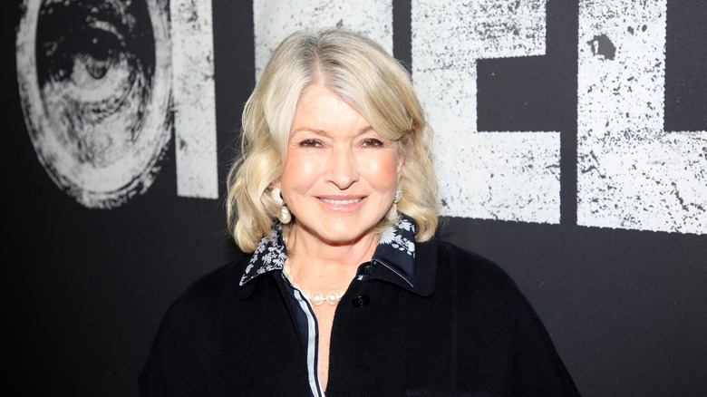 Martha Stewart on re carpet in black shirt, smiling at the camera