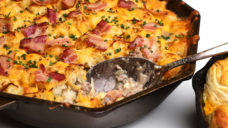 Cheesy casserole with spoon inside