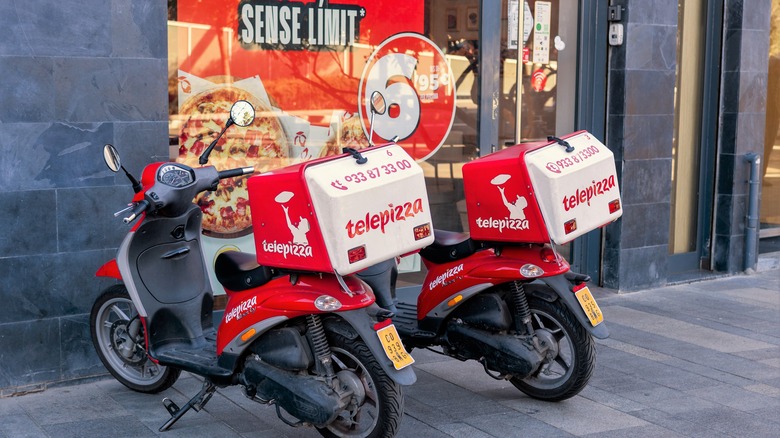 Delivery motorbikes outside a Telepizza location in Barcelona.
