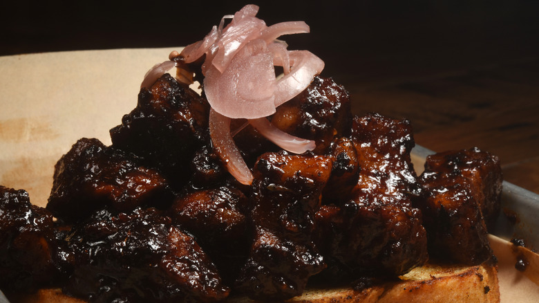 charred burnt ends topped with onions
