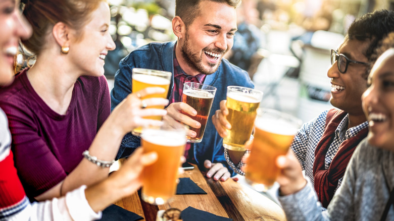 Group of friends toasting with beer