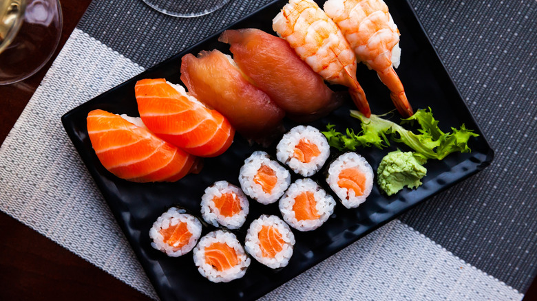 Close up of salmon maki rolls and nigiri sushi