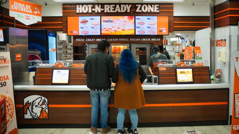 Customers placing their order at a Little Caesar's pizza restaurant