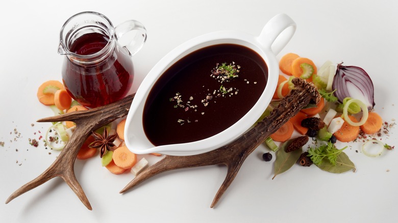 Worcestershire sauce surrounded by the ingredients used to make it