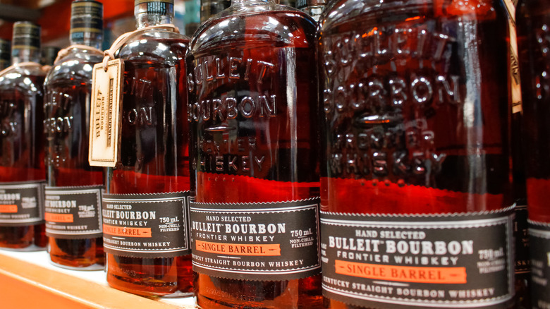 Bottles of Bulleit Bourbon lined in a grocery store aisle