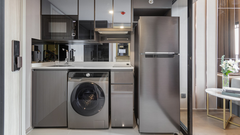 kitchen appliances including microwave, washer, and refrigerator