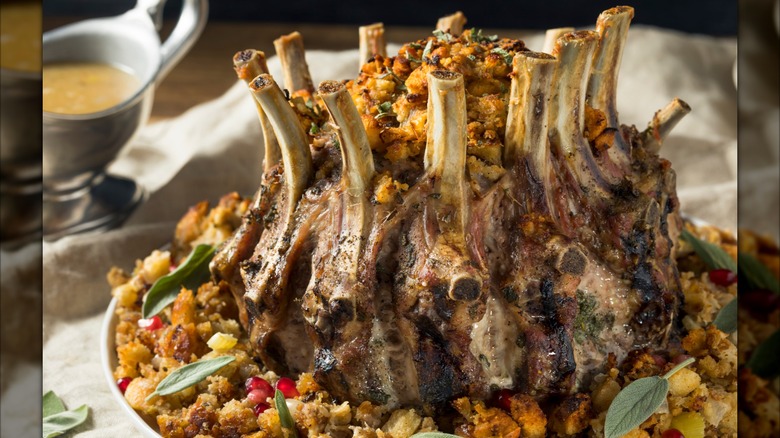 A festive crown roast of pork is photographed at a close distance.
