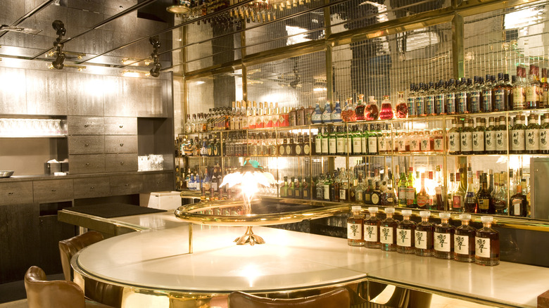 An elegant mirror situation behind liquor bottles at a bar