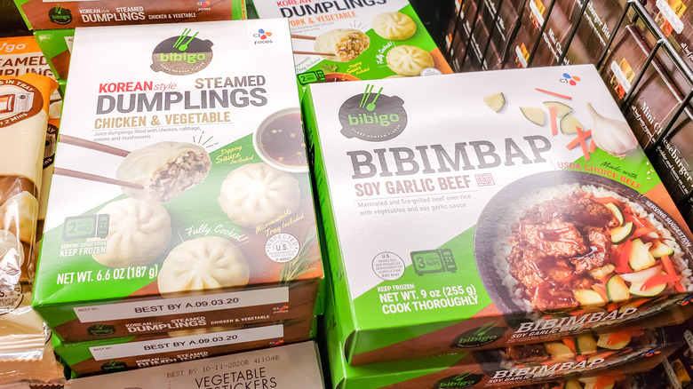Boxes of Bibigo dumplings and soy garlic beef in wire cart