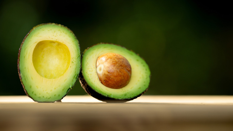 Close up of a sliced avocado with pit