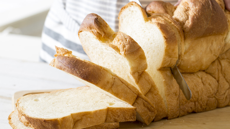Knife slicing white bread