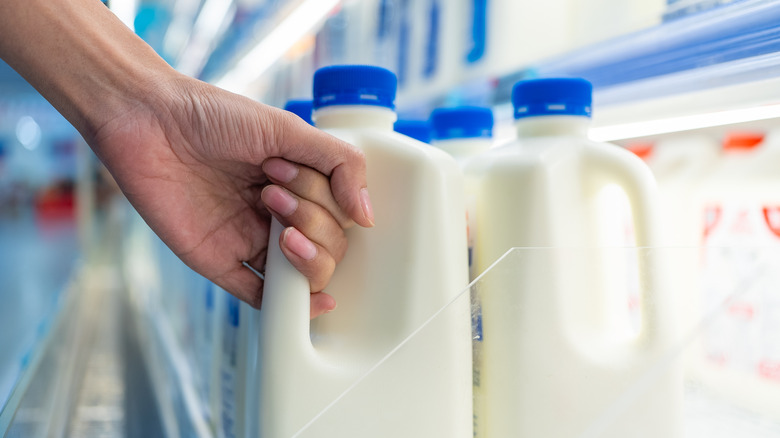 Hand grabbing a milk container