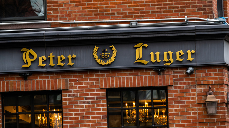 The exterior of Peter Luger, complete with logo, while showing its red brick facade