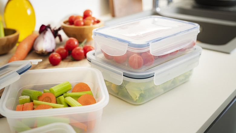 Chopped fresh vegetables in plastic storage containers