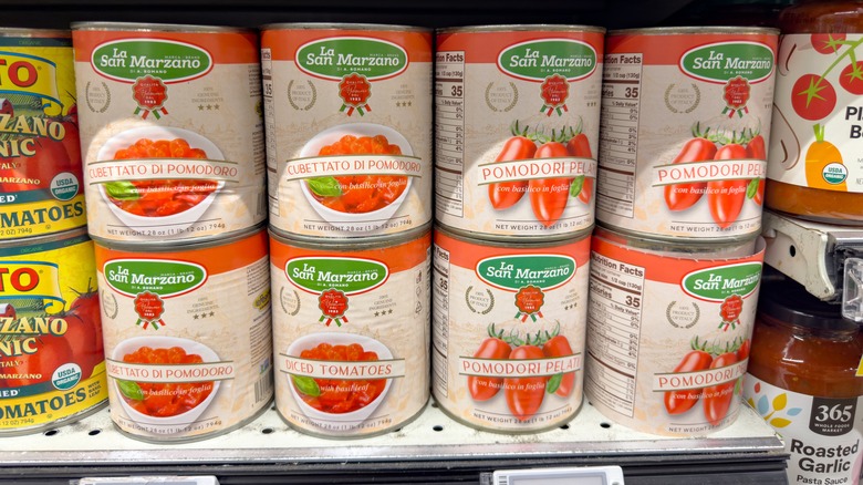 Canned tomatoes on display in the grocery store