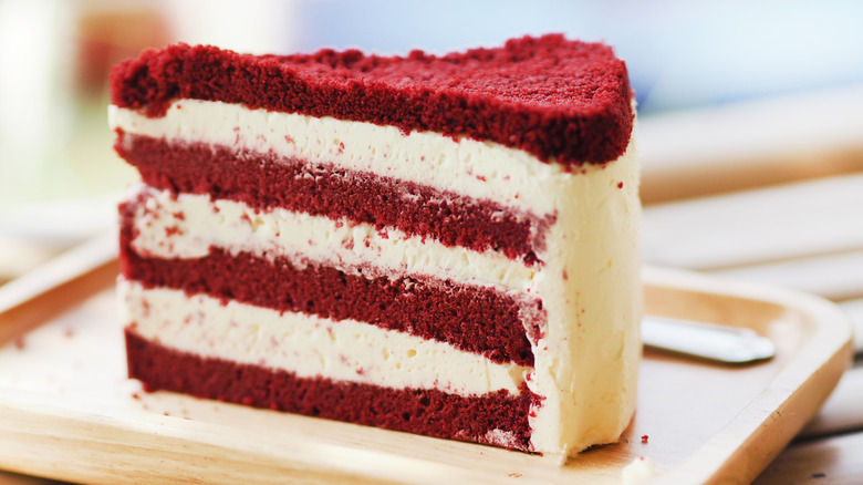 A closeup of a slice of red velvet layer cake.