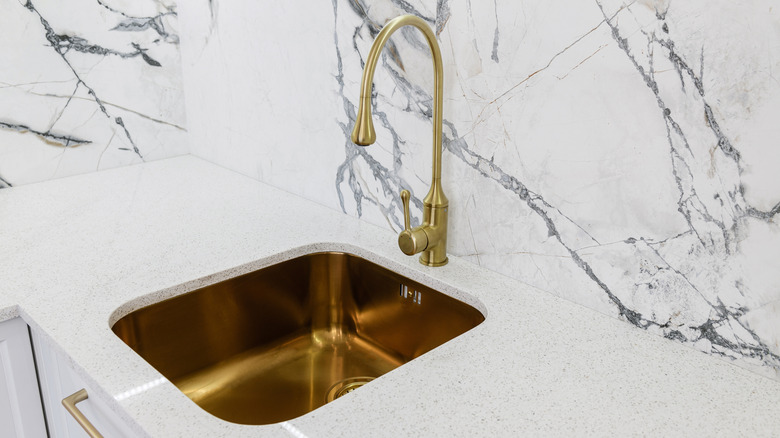 new copper sink in a kitchen with white marble counters