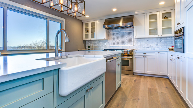 kitchen with green cabinets and farmhouse sink