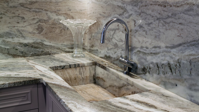 stone kitchen sink that matches with counter and backsplash
