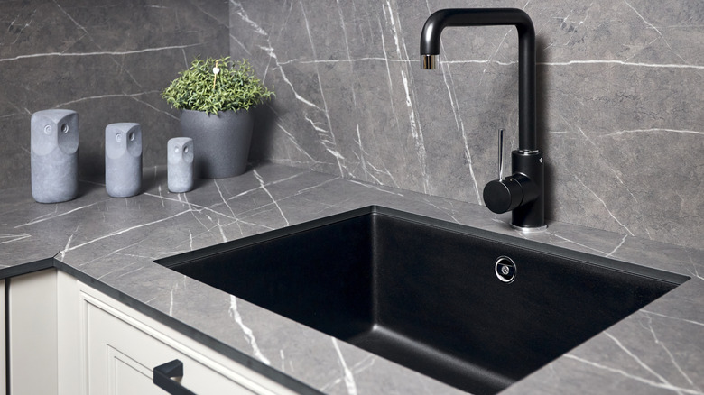 black granite composite sink in a modern kitchen.