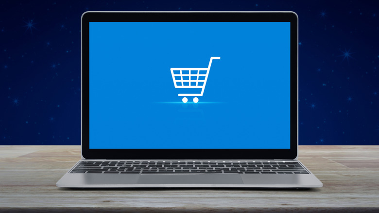 Laptop with blue screen with white shopping cart logo