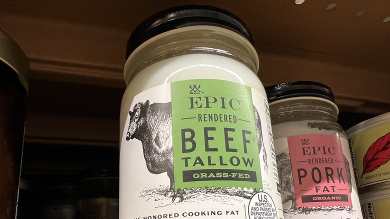 a jar of beef tallow on shelf in a cupboard