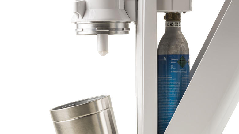 SodaStream cylinder and machine on white background