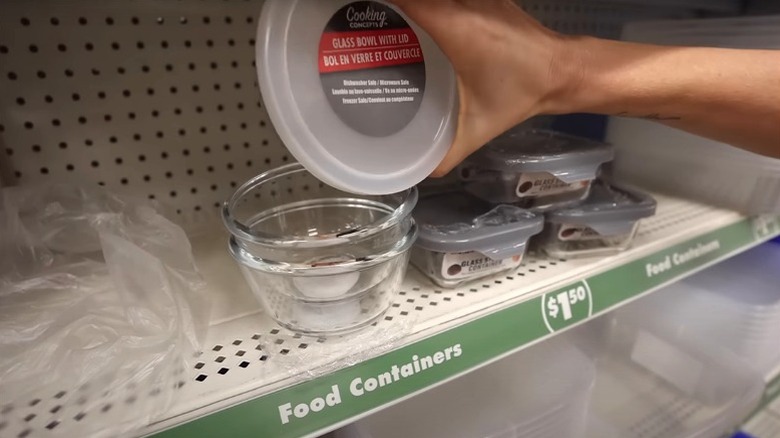 Person holding glass Dollar Tree storage container