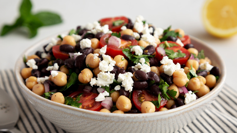 a black bean chickpea and cheese salad against a white background