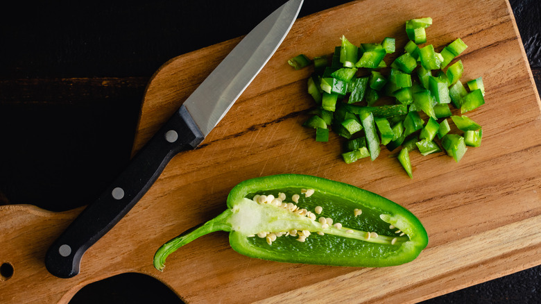 Sliced jalapeños on cutting board