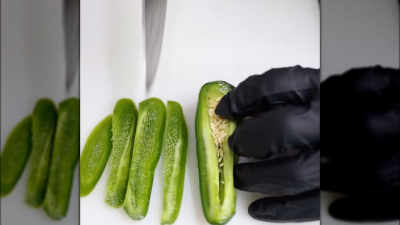 Chef slicing jalapeños