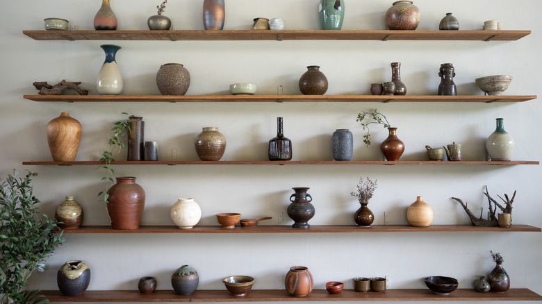 Decorative stoneware pieces on shelves