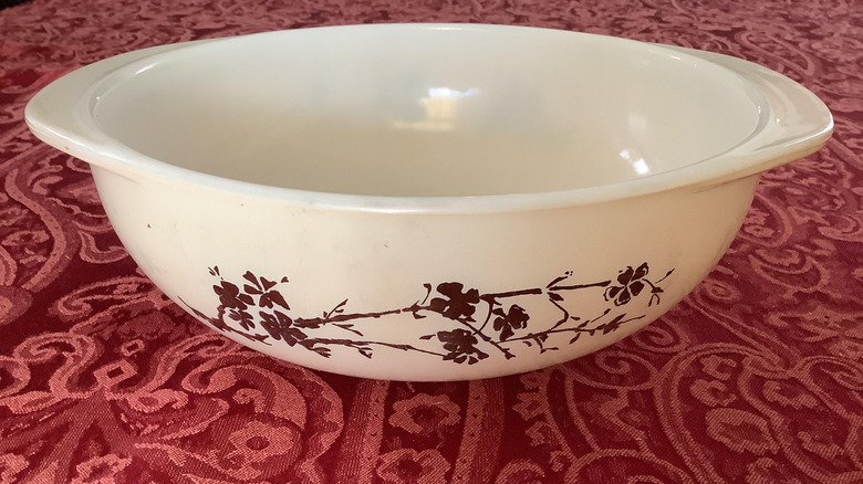 A white Pyrex bowl with golden branches