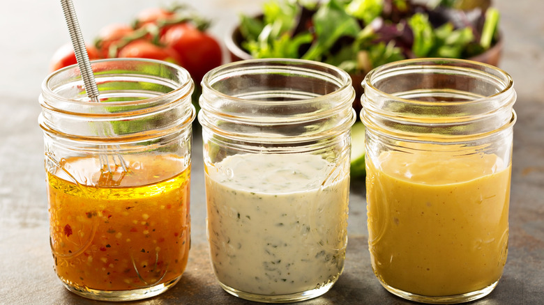 Three jars of assorted salad dressing