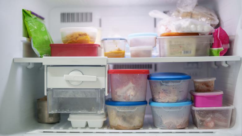 Freezer shelves with food in plastic containers