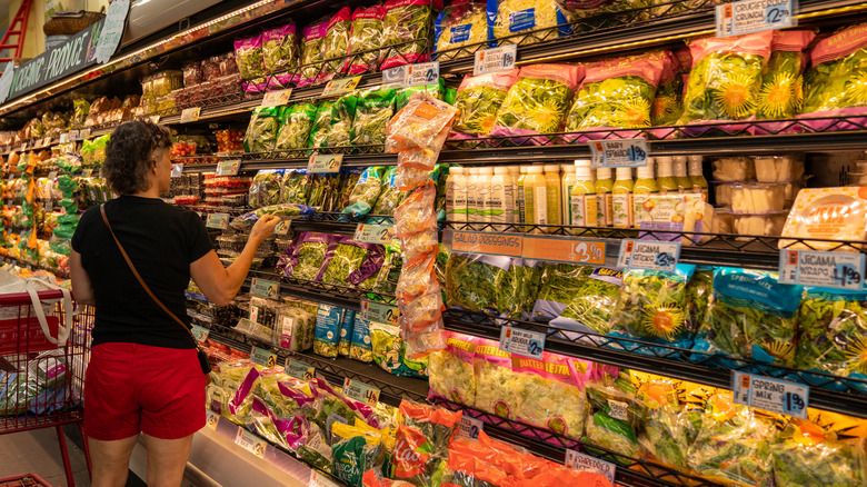 Person in the fresh produce aisle of a Trader Joe's outlet