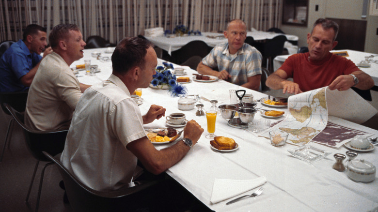 Apollo 11 astronauts enjoying steak and eggs breakfast