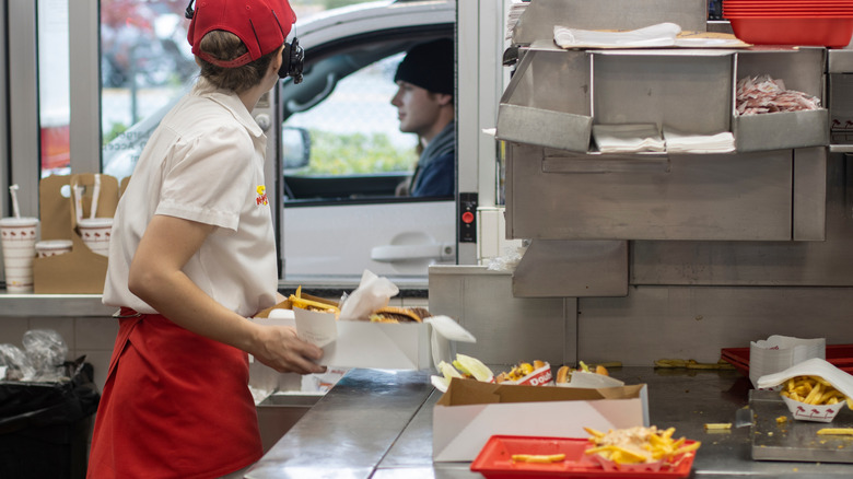 In-N-Out Burger employee working the drive thru