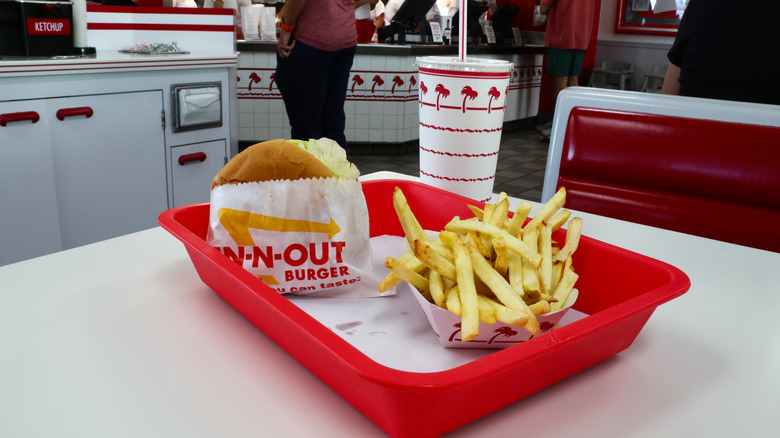 A tray with an In-N-Out Burger, fries, and a drink
