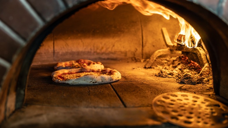 Pizzas in a brick oven