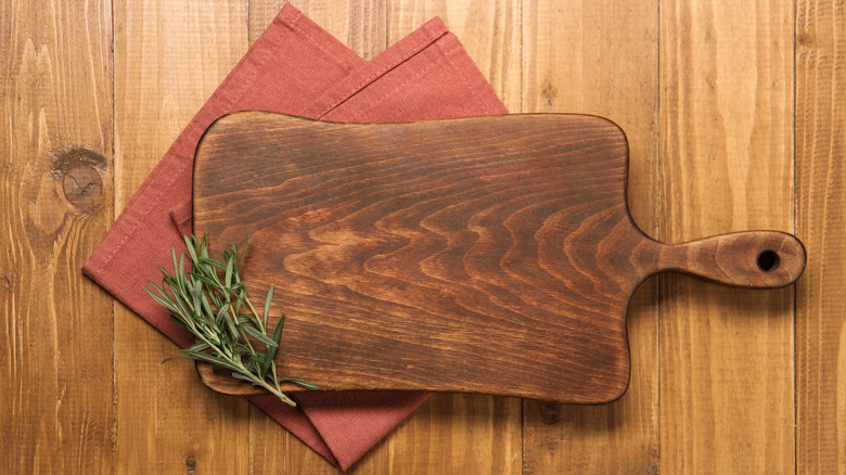 wooden charcuterie board with rosemary sprigs