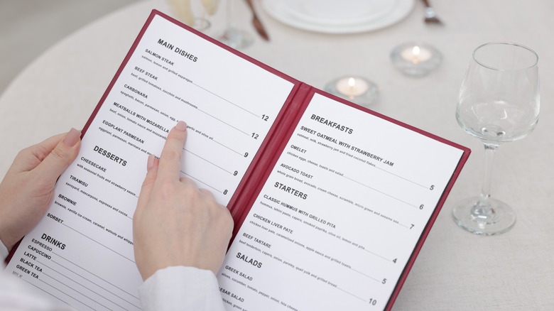 Hands pointing to an item on a menu