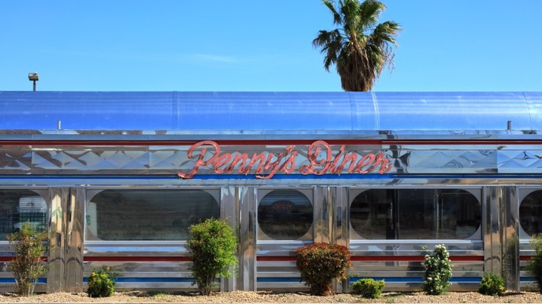 A Penny's Diner in California with metal siding and a neon sign typical of the mid-20th Century.