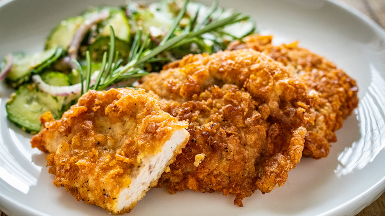 Breaded chicken on plate with salad