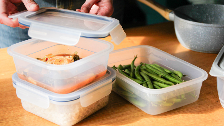 person putting leftovers in containers