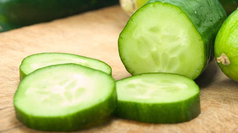 sliced cucumbers on cutting board